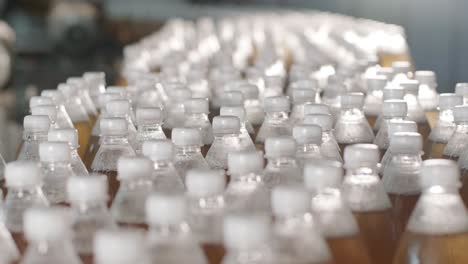 conveyor belt with bottles for juice or water at a modern beverage plant. modern production of sweet soda water