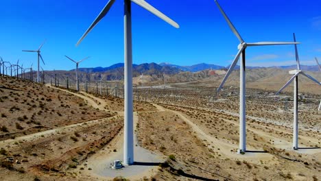 Windmills,-wind-turbines--aerial-4k-drone-boom-up-and-ascend,-energy,-green,-renewable,-huge-power-generating-farm-on-desert-hills,-Mt-San-Gorgonio-in-BG-in-Palm-Springs,-Coachella-Valley,-Cabazon,-CA