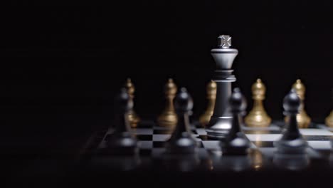 Dramatic-lighting-on-chess-board---two-kings-facing-off,-trucking-right-shot