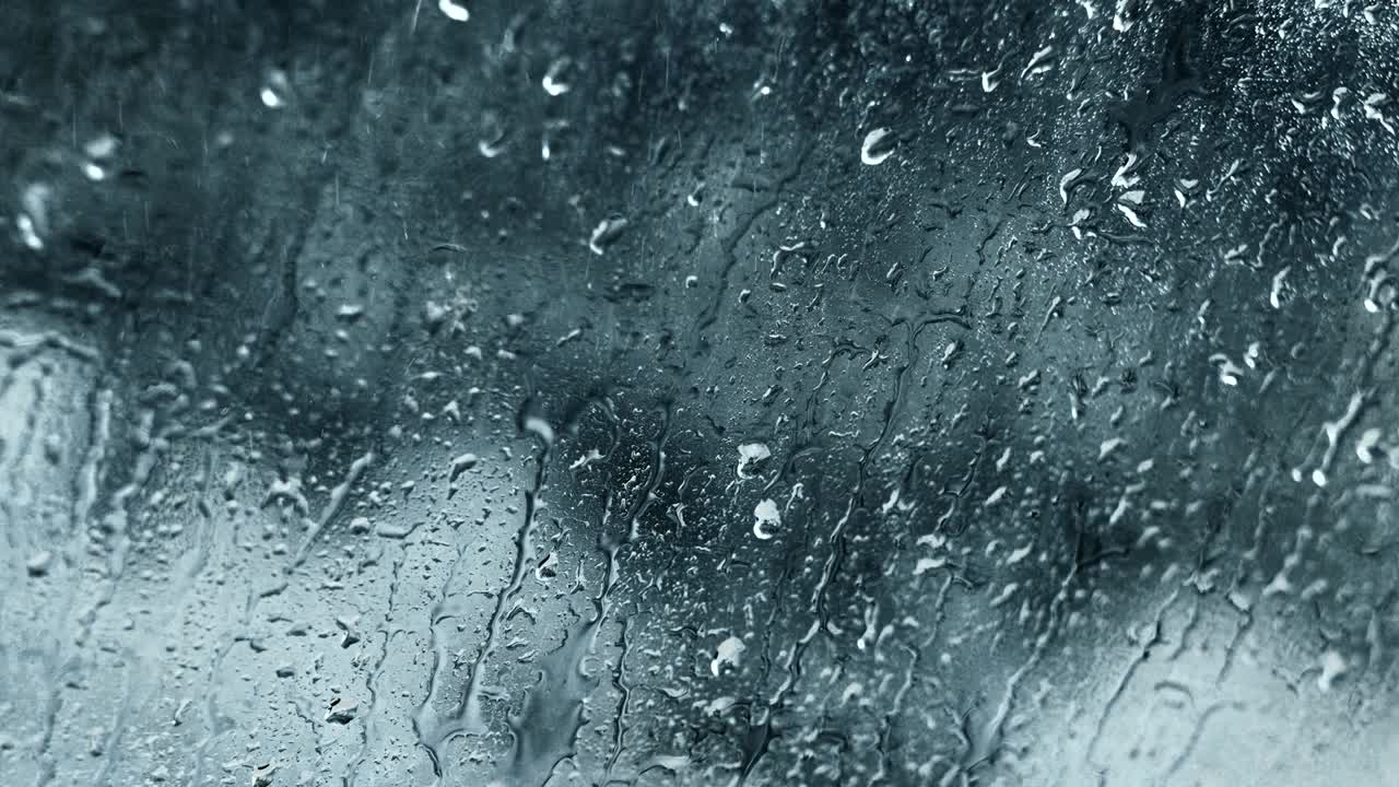 gotas de lluvia movimiento agua fondo de vidrio gris