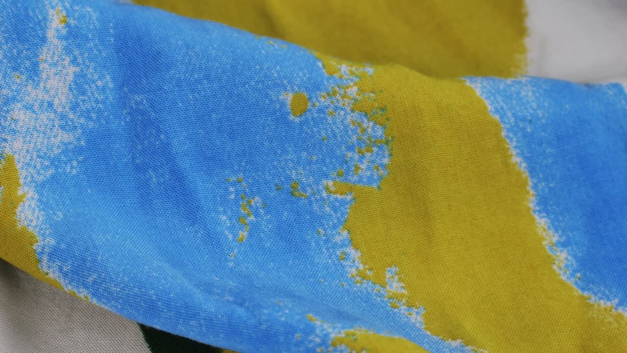 Colorful textile cloth texture close-up macro. Print clothes. Fashion fabric multicolor.