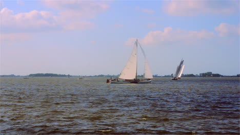 traditional sailing boat making a turn around a buoy