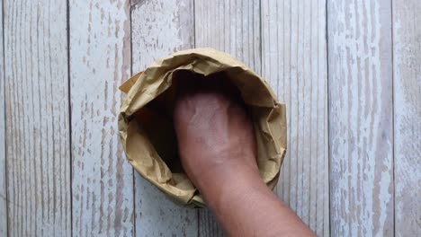 green apples in a brown paper bag