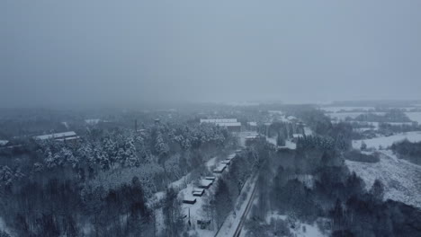 snowy aerial view of an abandoned industrial area