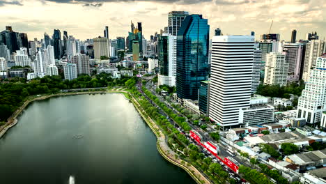 sunset drone hyperlapse view over lake ratchada, traffic and bangkok cityscape