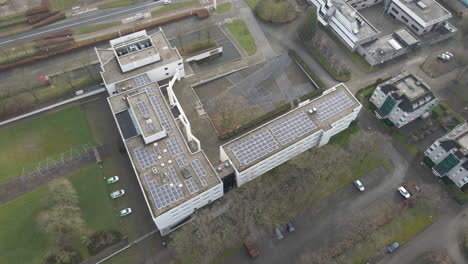 aerial of solar panels on office building rooftop