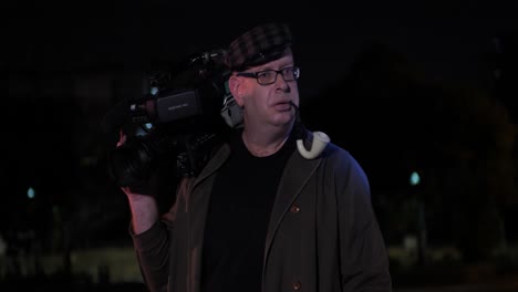 portrait of hilarious detective smoking pipe using vintage camera turns around and walk away