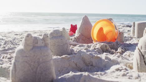 video of plastic toys lying on sand on beach