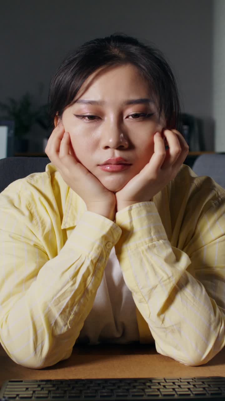 Woman Looking Bored at her Desk