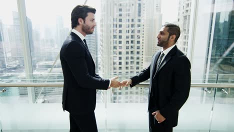 multi ethnic businessmen meeting in financial tower downtown