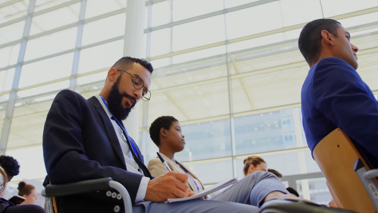 Multi ethnic business people attending a business seminar 4k