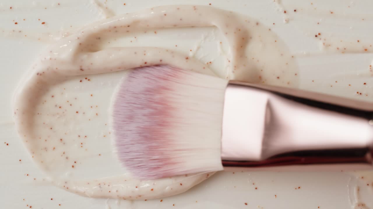 Applying a face scrub with a make-up brush