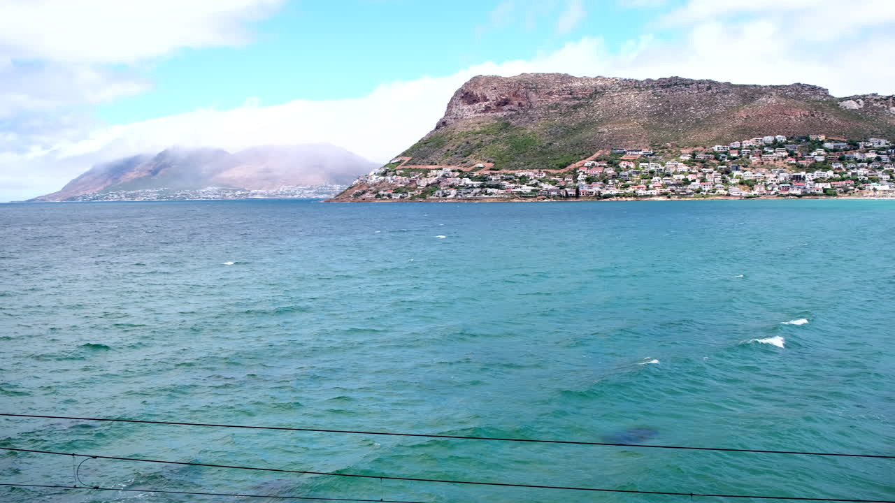Sweeping view over Atlantic ocean towards stunning Fish Hoek white sand beach