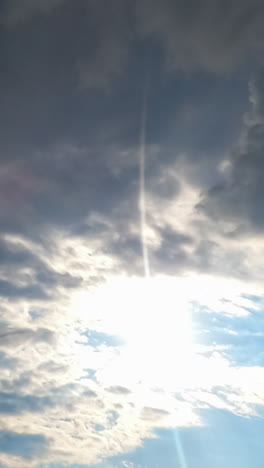 heavy grey clouds accumulating quickly. sun appears in the blue sky for some period. timelapse. vertical video