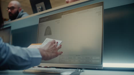 fingerprint scanning at an airport check-in counter