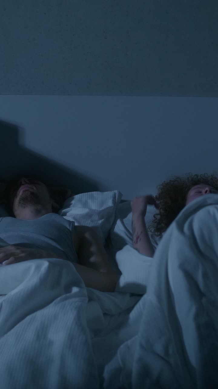 pareja durmiendo en la cama por la noche