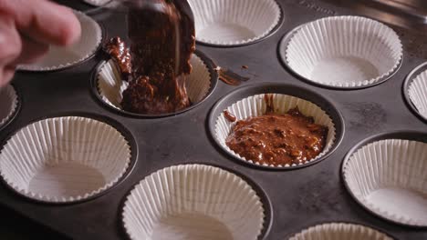 pouring mixture of chocolate oat cake into baking mold with baking paper