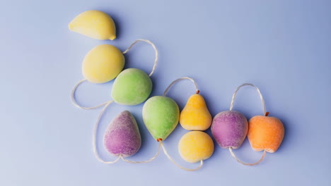 colorful frosted fruit garland on light blue background