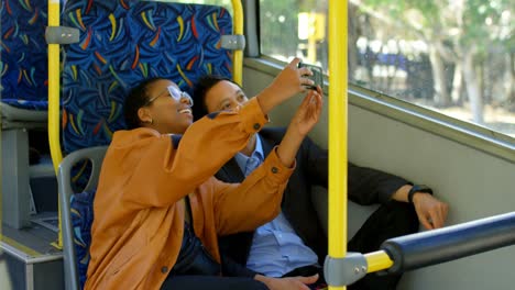 couple taking photo on mobile phone while travelling in bus 4k