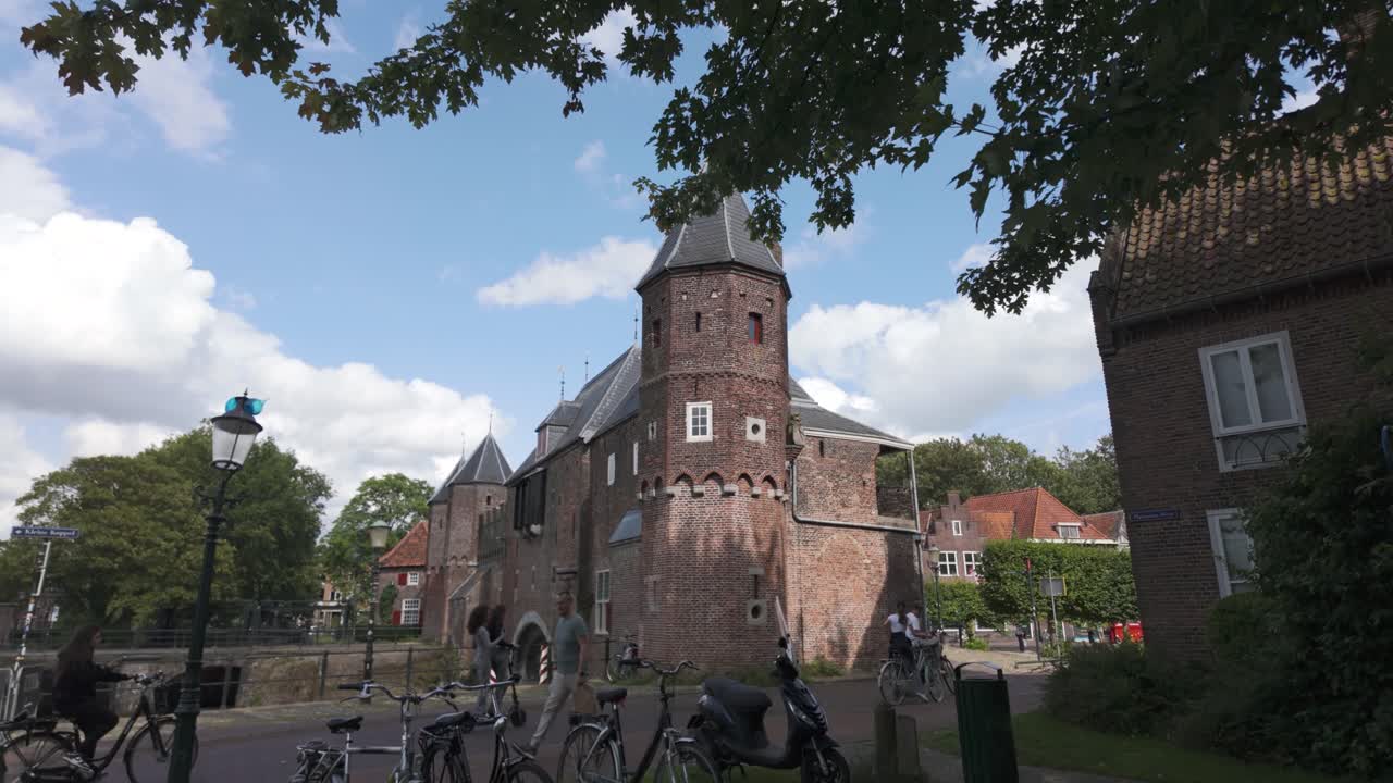 Exterior establishing view of Koppelpoort’s architectural details with canal reflections in Amersfoort