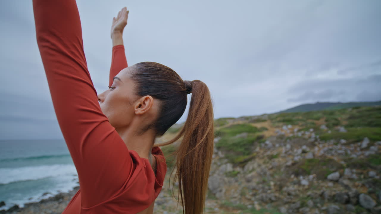 Sporty girl fitness routine in coastal cloudy nature closeup. Slim sportswoman