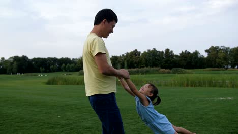 father spinning around his cute little daughter