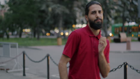 man walking in city park at dusk