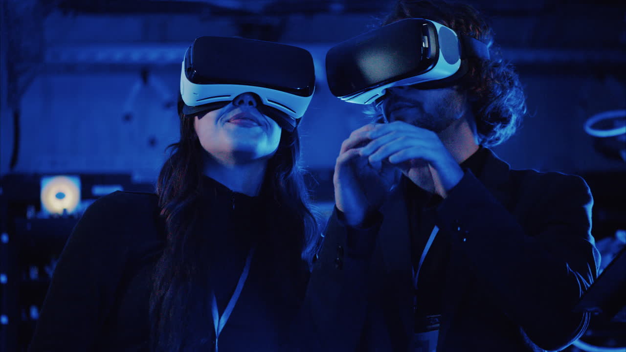 A man and a woman using Virtual Reality headsets in a server room