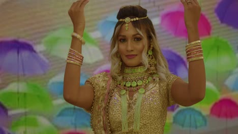 in traditional indian attire, a young woman of east indian heritage gracefully holds bangles near her face