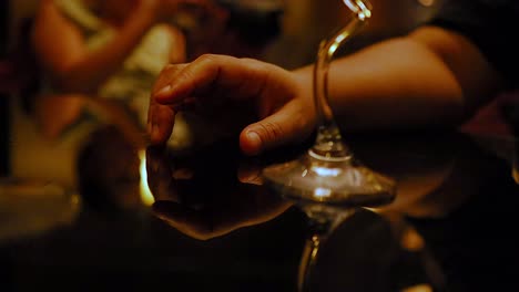 hand tapping rhythmically on a reflective surface