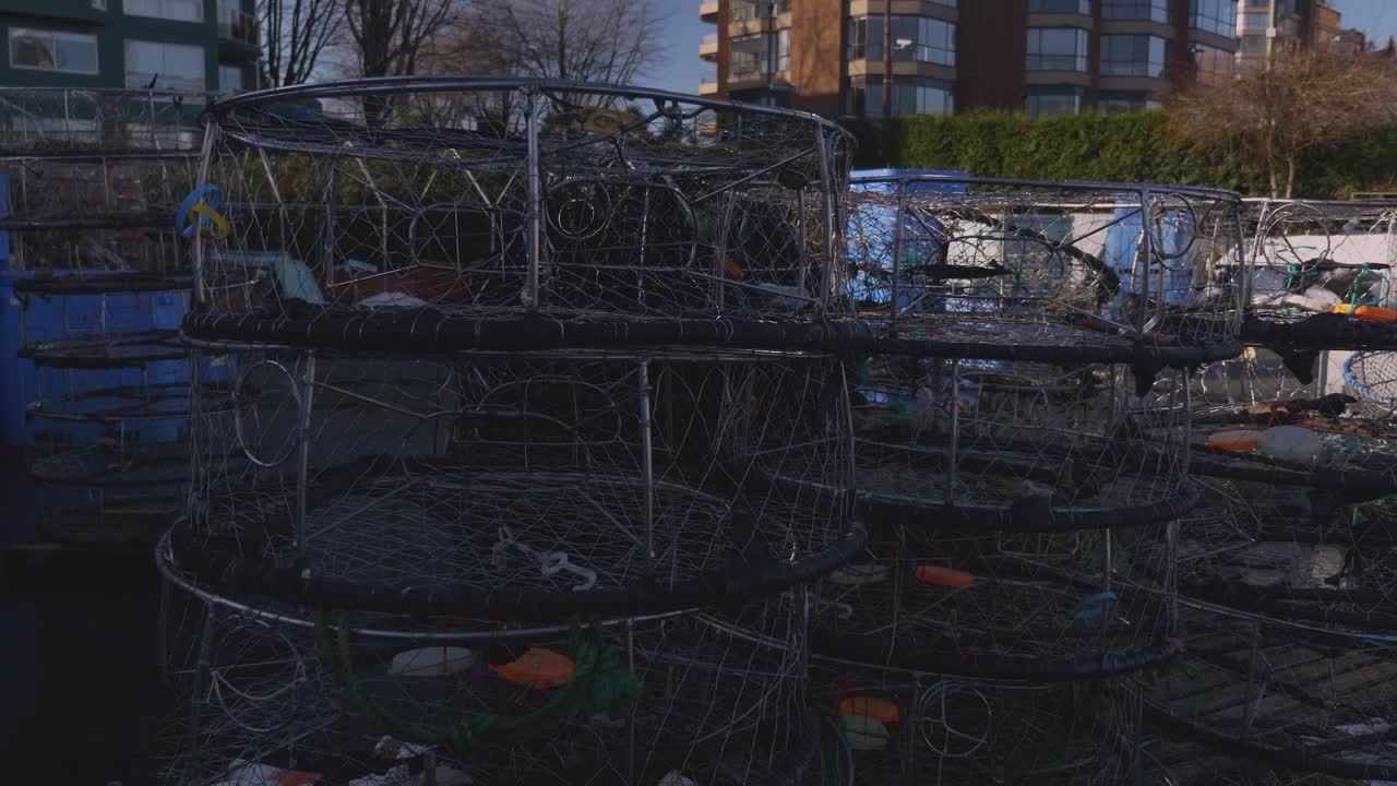 A close-up of crab fishing cages piled up at the fishing dock ready for use during the crabbing harvesting season lobster seafood industry