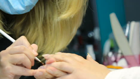 nail care and manicure. woman hands in a nail salon receiving a manicure