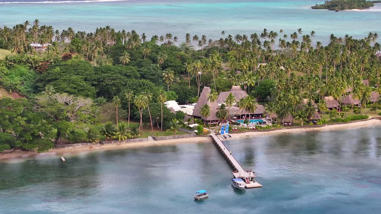 Aerial reveal of paradise tropical island Vanua Levu, travel destination with resort and coastline.