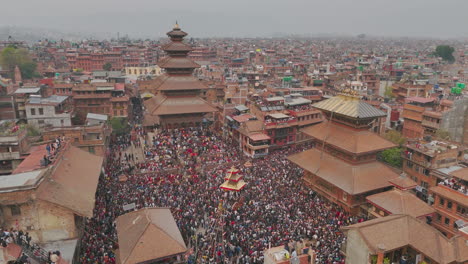 drone shot vibrant celebration of bisket jatra at bhaktapur durbar square festival unites diverse ethnic groups in nepal, newari traditions chariot pulling, architectural beauty of kathmandu valley.