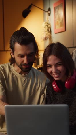 couple watching laptop together at home