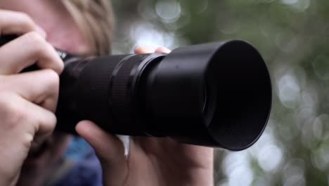 Man-handling-camera-in-slow-motion,-good-angle-at-day-light