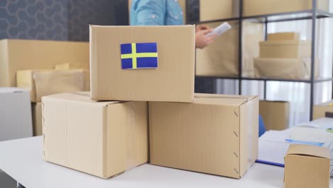 flag of sweden on a logistics cargo package.