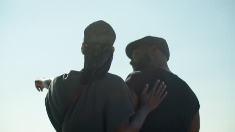 back view of gays admiring cityscape from observation point