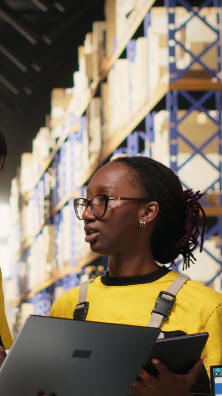 Vertical Video Black workers team preparing merchandise for dispatch in large warehouse