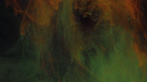 dissolution of blue particles of luminous colors in a yellow-green background, in smoke.