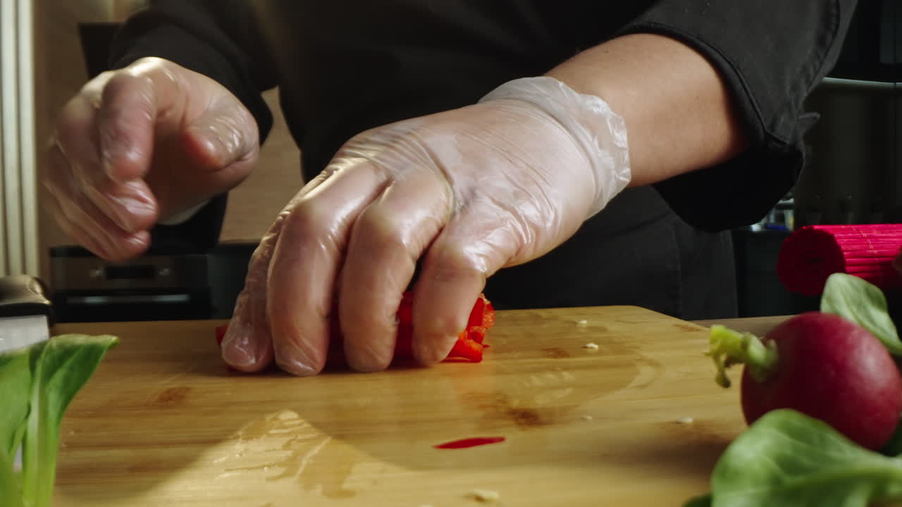 Chef Slicing Red Bell Pepper in a Kitchen
