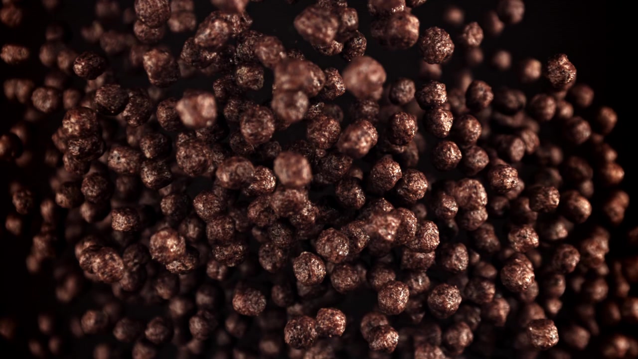 Chocolate Cereal Balls Floating in Slow Motion on Black Background