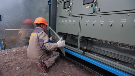 electrician working on outdoor electrical panel