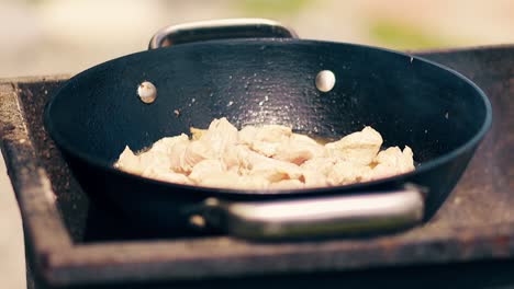 Close-up-Slow-motion-Pork-meat-is-fried-in-saucepan-on-charcoal