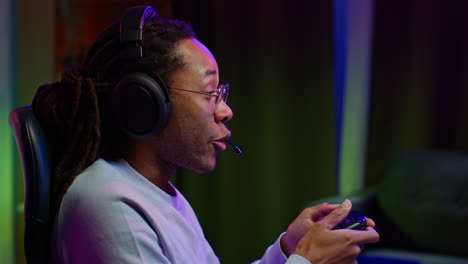 man playing video games with headphones and controller