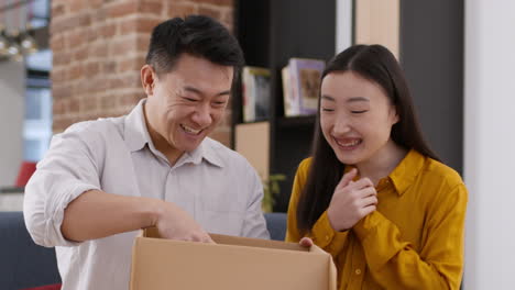 excited couple unboxing a gift or moving items