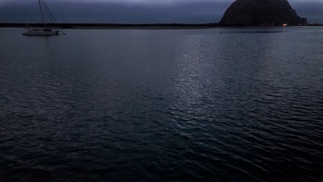 gimbal wide panning shot of a sea otter diving for food at sunset in morro bay, california. 4k