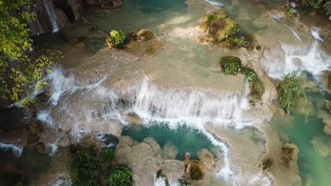 amazing cascade falls with turquoise clear water, aerial birdseye panorama