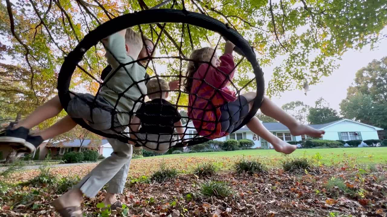 Family Fun: Kids Swinging in the Backyard