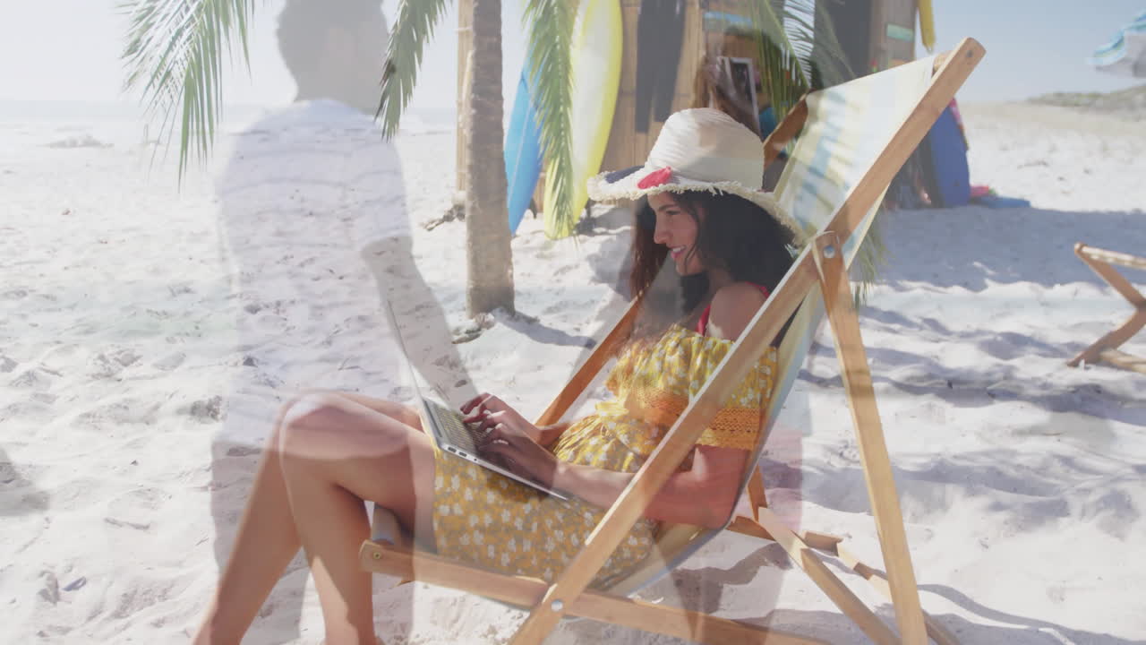 woman typing on laptop at beach deckchair, showing floating tech charts and sunlit surfboards